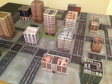 Load image into Gallery viewer, 4’x4’ gaming mat with a City Blocks Urban theme, marketed for tabletop gaming, accompanied by a black canvas zipper bag TableWar neoprene Tournament Tabletop Game mat