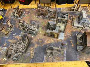 60x44 inch gaming mat with a Ruined city Urban theme, marketed for tabletop gaming, a black canvas zipper bag included. A TableWar neoprene Tournament Tabletop warhammer Game Battle mat 