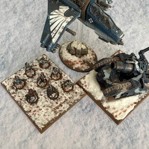 ‘Snow’ design shown with miniatures for scale purposes 30”x22”’ gaming mat with a Snow winter theme, marketed for tabletop gaming, accompanied by a black canvas zipper bag TableWar neoprene KillTeam Tournament Tabletop Game mat 