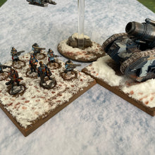Load image into Gallery viewer, ‘Snow’ design shown with miniatures on our gaming mat with a Snow winter theme, marketed for tabletop gaming, accompanied by a black canvas zipper bag TableWar neoprene Tournament Tabletop Game mat 
