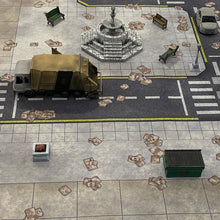 Load image into Gallery viewer, 3x3 gaming mat with a Tech City Block theme, featuring a city street with marketed for tabletop gaming, accompanied by a black canvas zipper bag TableWar neoprene Marvel Tournament Tabletop Game mat

